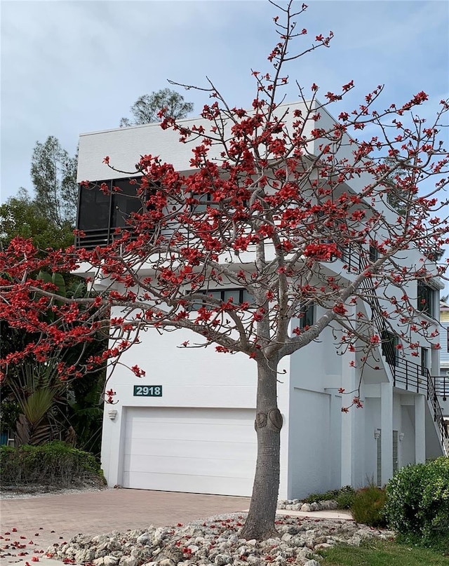2918 Avenue Ave E, Holmes Beach, FL 34217 - view of property exterior with concrete driveway, an attached garage, and stucco siding