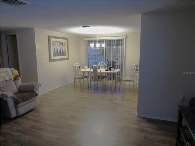 9835 El Camino Real Ave, Port Richey, FL 34668 - dining room featuring a chandelier, dark wood finished floors, and baseboards