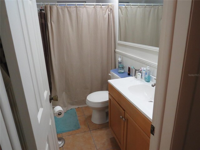 9835 El Camino Real Ave, Port Richey, FL 34668 - bathroom with toilet, vanity, tile patterned flooring, and a shower with shower curtain