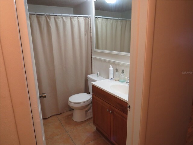 9835 El Camino Real Ave, Port Richey, FL 34668 - bathroom featuring toilet, tile patterned floors, and vanity