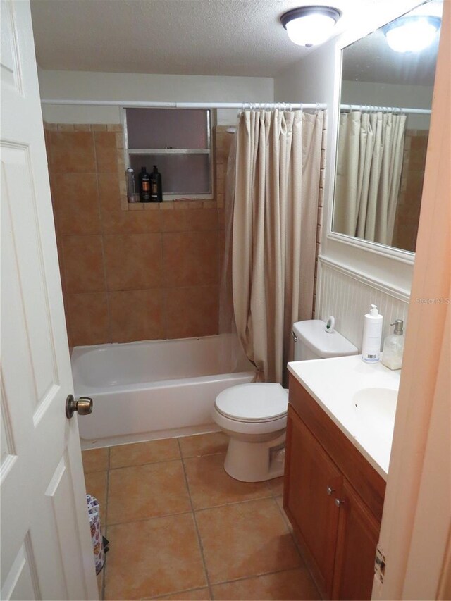 9835 El Camino Real Ave, Port Richey, FL 34668 - bathroom featuring vanity, tile patterned flooring, shower / bathtub combination with curtain, and toilet