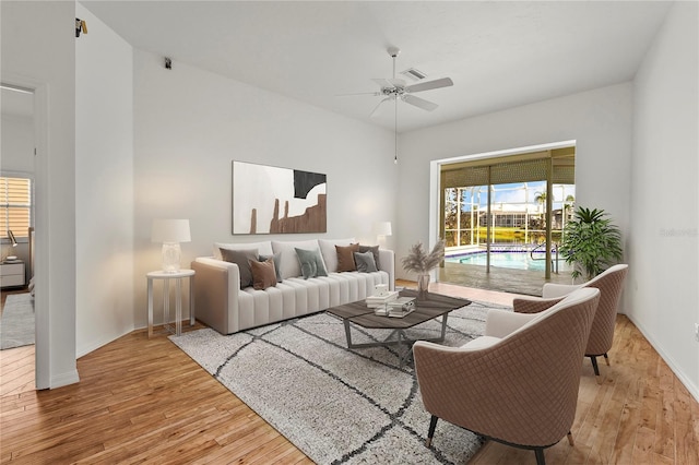 4180 Via Mirada, Sarasota, FL 34238 - living area featuring wood finished floors, ceiling fan, and plenty of natural light