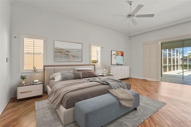 4180 Via Mirada, Sarasota, FL 34238 - bedroom featuring access to exterior, wood finished floors, crown molding, multiple windows, and baseboards