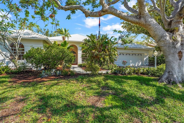 4180 Via Mirada, Sarasota, FL 34238 - view of front facade with an attached garage, a front lawn, and stucco siding