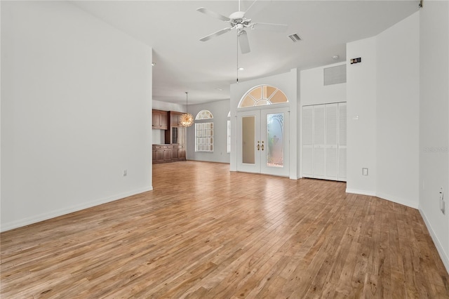 4180 Via Mirada, Sarasota, FL 34238 - unfurnished living room featuring light wood finished floors, a ceiling fan, baseboards, and a chandelier