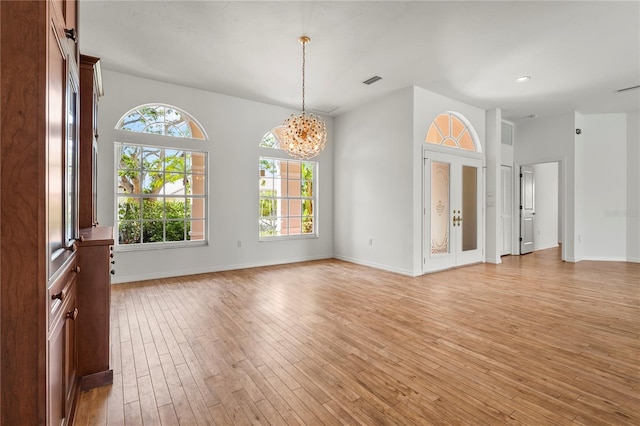 4180 Via Mirada, Sarasota, FL 34238 - spare room featuring plenty of natural light, light wood finished floors, a chandelier, baseboards, and recessed lighting