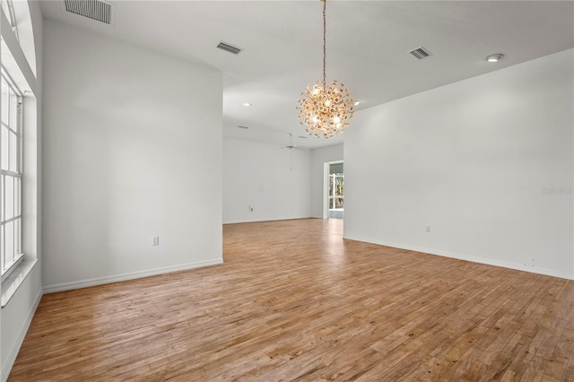 4180 Via Mirada, Sarasota, FL 34238 - spare room with a chandelier, light wood finished floors, a ceiling fan, baseboards, and recessed lighting