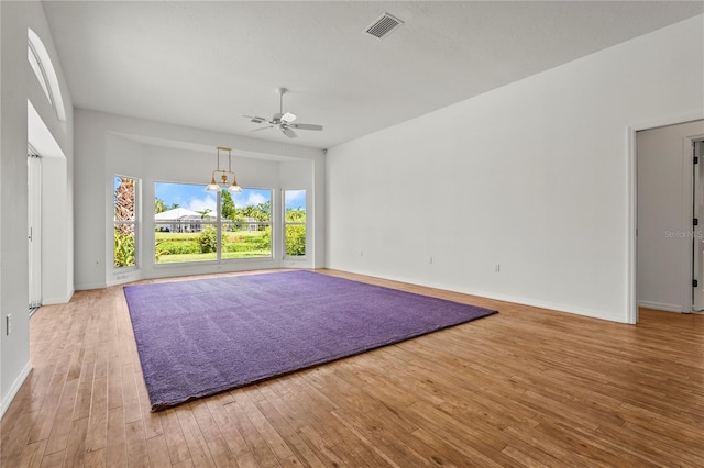 4180 Via Mirada, Sarasota, FL 34238 - spare room with wood finished floors, baseboards, a ceiling fan, and a chandelier