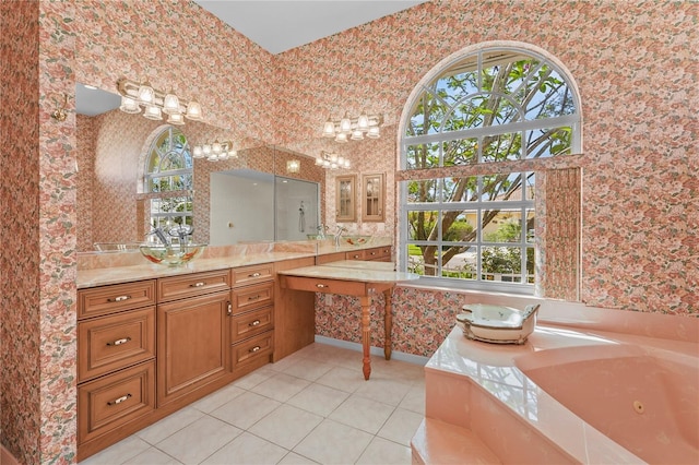 4180 Via Mirada, Sarasota, FL 34238 - full bath with tile patterned flooring, healthy amount of natural light, wallpapered walls, a jetted tub, and vanity