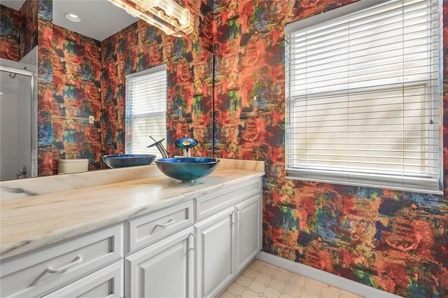 4180 Via Mirada, Sarasota, FL 34238 - full bath with wallpapered walls, baseboards, healthy amount of natural light, a shower with door, and vanity