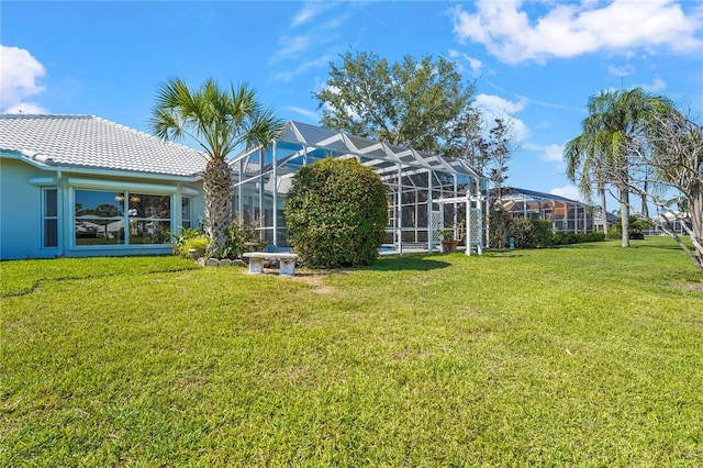 4180 Via Mirada, Sarasota, FL 34238 - rear view of house featuring a lawn, a tile roof, and stucco siding
