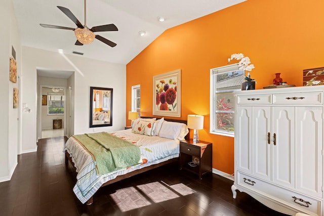 bedroom featuring ceiling fan, visible vents, dark wood finished floors, baseboards, and high vaulted ceiling