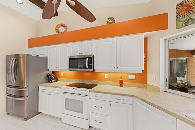 kitchen with light countertops, white cabinets, a ceiling fan, appliances with stainless steel finishes, and light tile patterned floors