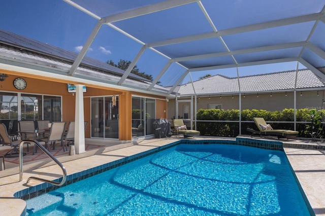 pool featuring a patio and glass enclosure