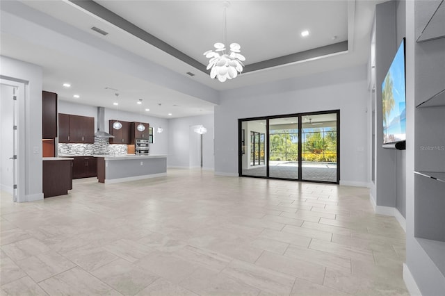 8229 Grande Shores Dr, Sarasota, FL 34240 - unfurnished living room featuring a chandelier, baseboards, and recessed lighting