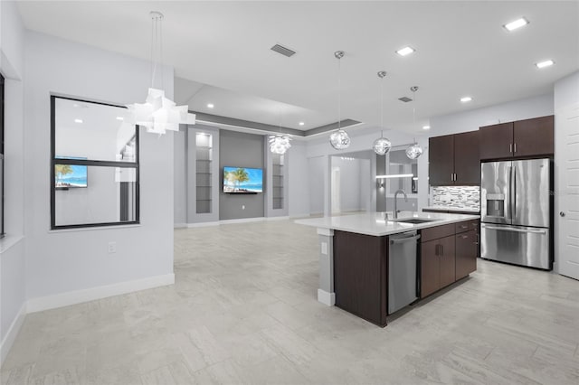 8229 Grande Shores Dr, Sarasota, FL 34240 - kitchen with appliances with stainless steel finishes, a sink, dark brown cabinets, light countertops, and baseboards
