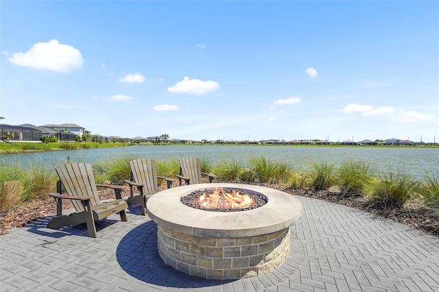 8229 Grande Shores Dr, Sarasota, FL 34240 - view of patio featuring an outdoor fire pit and a water view
