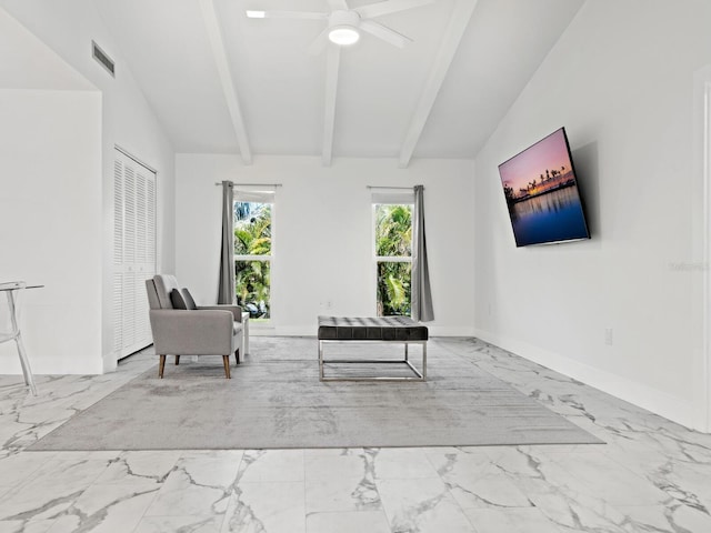 sitting room with vaulted ceiling with beams, marble finish floor, ceiling fan, and baseboards