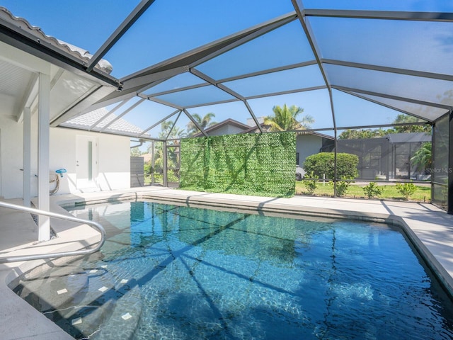 pool with a patio and glass enclosure