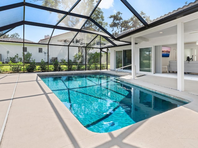 outdoor pool with a patio area and a lanai