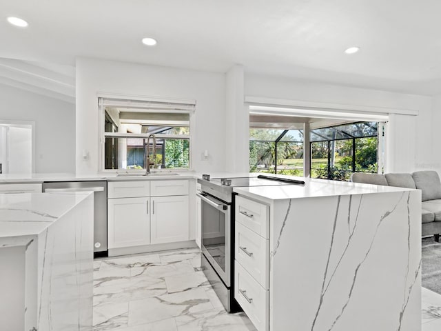 172 Sea Anchor Dr, Osprey, FL 34229 - kitchen with appliances with stainless steel finishes, a sink, recessed lighting, healthy amount of natural light, and light stone counters