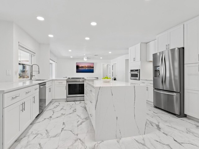 172 Sea Anchor Dr, Osprey, FL 34229 - kitchen with stainless steel appliances, a sink, recessed lighting, a center island, and ceiling fan