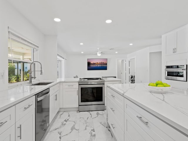 172 Sea Anchor Dr, Osprey, FL 34229 - kitchen featuring appliances with stainless steel finishes, a sink, recessed lighting, a ceiling fan, and light marble finish flooring