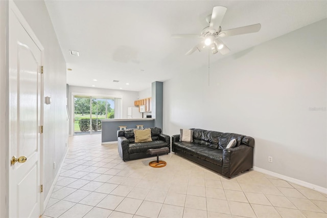 2353 Rosewood Ln, North Port, FL 34289 - living area featuring light tile patterned floors, baseboards, and ceiling fan