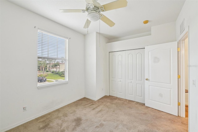 2353 Rosewood Ln, North Port, FL 34289 - unfurnished bedroom with carpet flooring, a closet, baseboards, and a ceiling fan