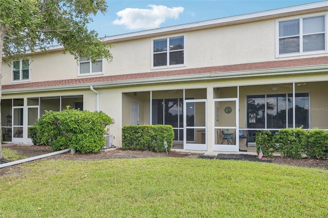 2353 Rosewood Ln, North Port, FL 34289 - back of house featuring stucco siding, a lawn, a sunroom, and central AC unit