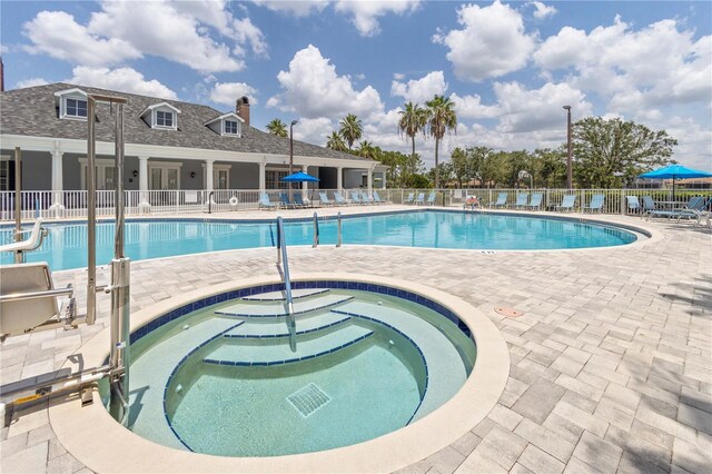 2353 Rosewood Ln, North Port, FL 34289 - community pool featuring a hot tub and a patio area