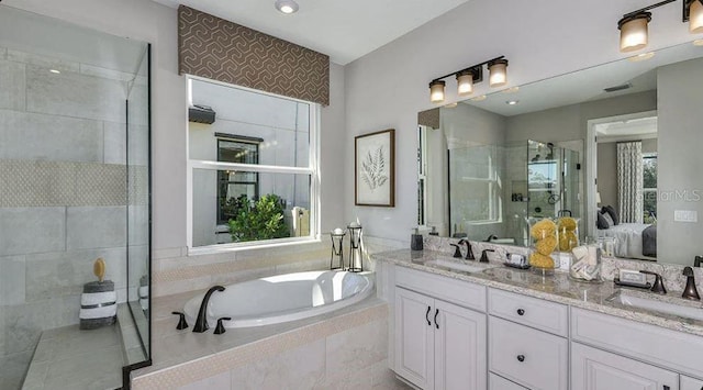 full bathroom featuring visible vents, a stall shower, a garden tub, and a sink