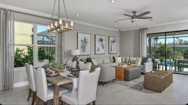 living area with ornamental molding, ceiling fan with notable chandelier, and plenty of natural light