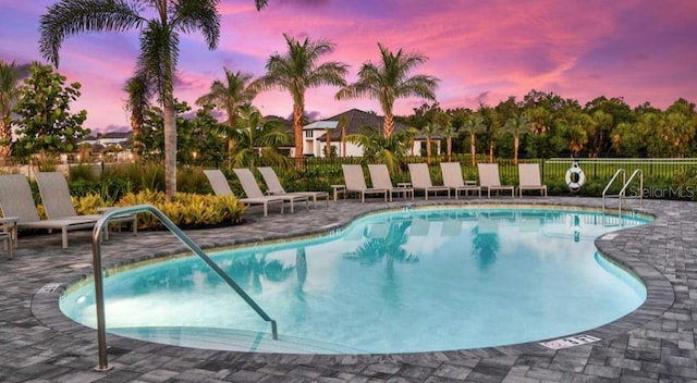 pool featuring fence and a patio area
