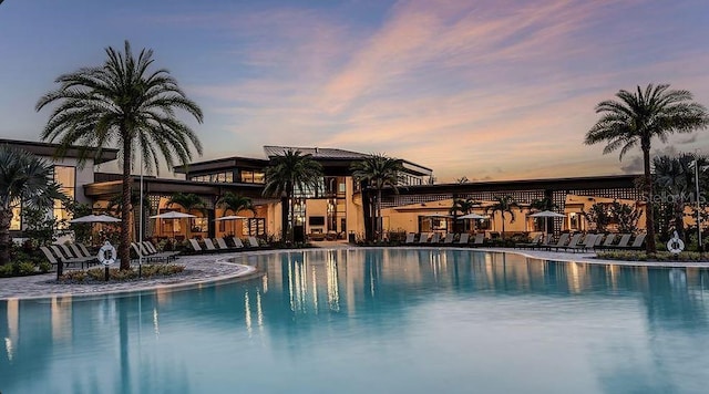 view of pool at dusk