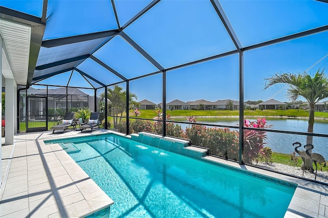 pool featuring a patio, a water view, glass enclosure, and a residential view