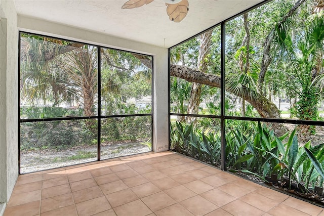 7876 Eagle Creek Dr, Sarasota, FL 34243 - unfurnished sunroom featuring a ceiling fan and tile patterned floors