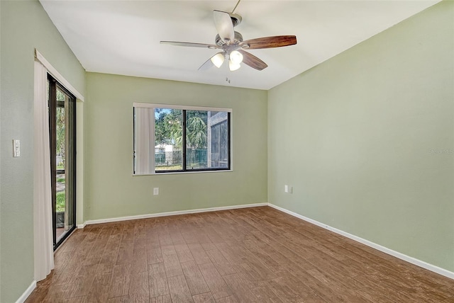 7876 Eagle Creek Dr, Sarasota, FL 34243 - empty room featuring wood finished floors, baseboards, and ceiling fan