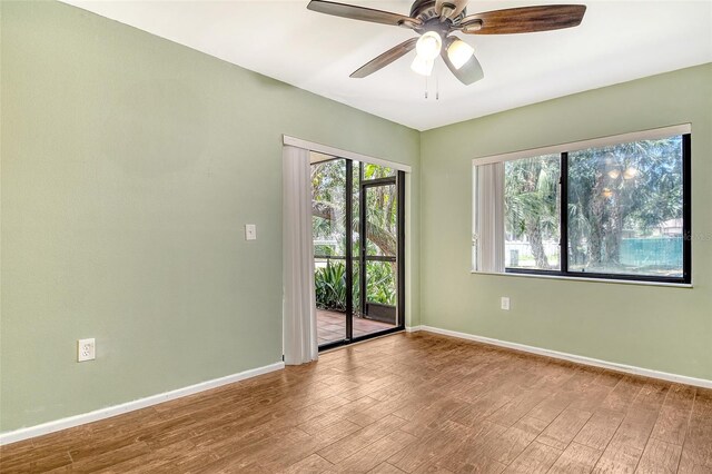 7876 Eagle Creek Dr, Sarasota, FL 34243 - unfurnished room with wood finished floors, baseboards, and ceiling fan