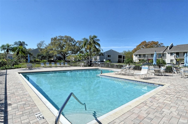 7876 Eagle Creek Dr, Sarasota, FL 34243 - community pool with fence, a patio, and a residential view