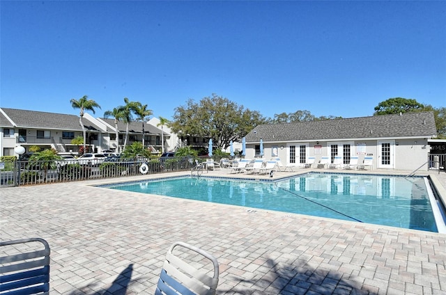 7876 Eagle Creek Dr, Sarasota, FL 34243 - community pool featuring fence, a patio, a residential view, and french doors