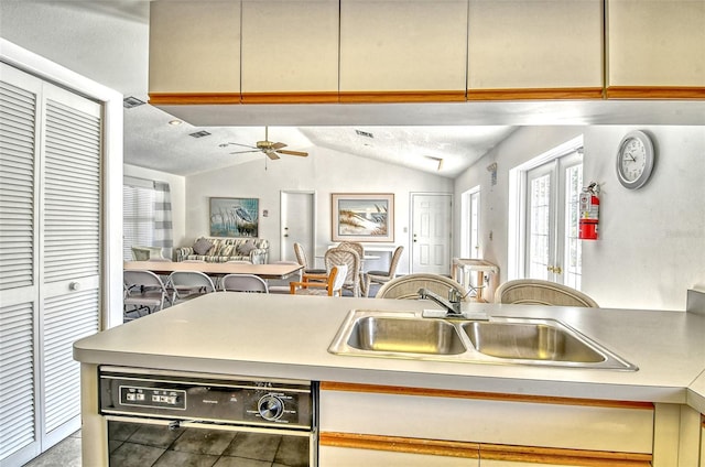 7876 Eagle Creek Dr, Sarasota, FL 34243 - kitchen featuring black dishwasher, open floor plan, vaulted ceiling, a sink, and ceiling fan