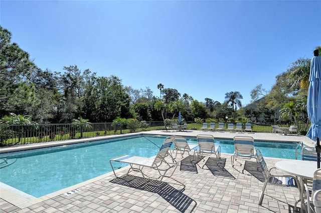 7876 Eagle Creek Dr, Sarasota, FL 34243 - community pool featuring fence, view of wooded area, and a patio area
