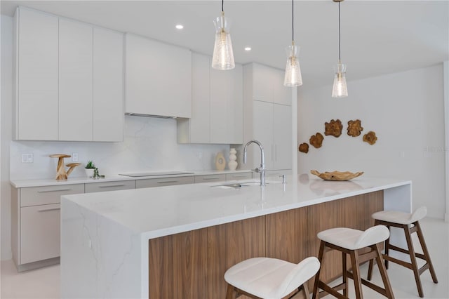 2596 Floyd St, Sarasota, FL 34239 - kitchen featuring a sink, black electric stovetop, white cabinets, modern cabinets, and recessed lighting