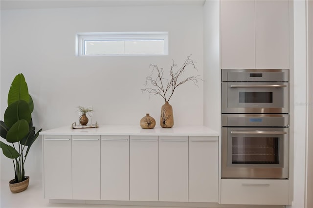 2596 Floyd St, Sarasota, FL 34239 - kitchen view of double oven, modern cabinets, white cabinetry, and light countertops