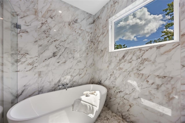 2596 Floyd St, Sarasota, FL 34239 - bathroom featuring a soaking tub, tile walls, and a marble finish shower