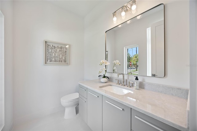 2596 Floyd St, Sarasota, FL 34239 - bathroom with toilet, tile patterned floors, vanity, and baseboards