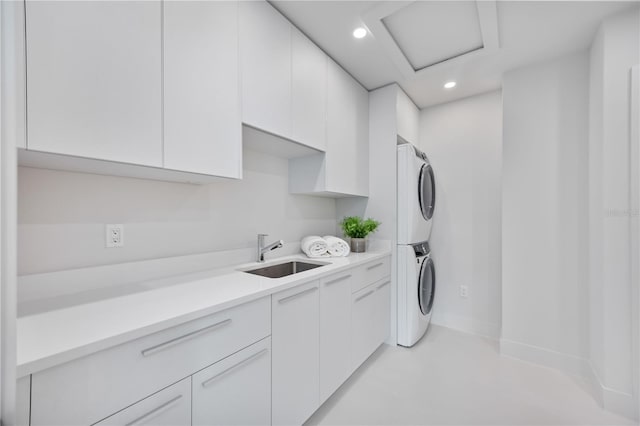 2596 Floyd St, Sarasota, FL 34239 - laundry area featuring stacked washer / drying machine, cabinet space, recessed lighting, and baseboards