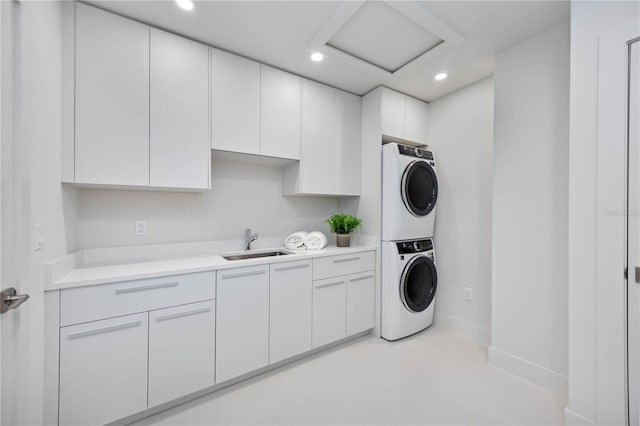 2596 Floyd St, Sarasota, FL 34239 - washroom with stacked washer and clothes dryer, cabinet space, attic access, recessed lighting, and baseboards