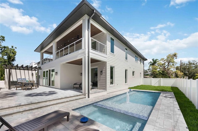 2596 Floyd St, Sarasota, FL 34239 - rear view of house featuring a balcony, a fenced backyard, a patio area, and outdoor dining area